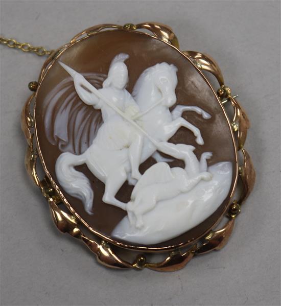 An Edwardian 9ct gold mounted oval cameo brooch, carved with St. George & the Dragon, 49mm.